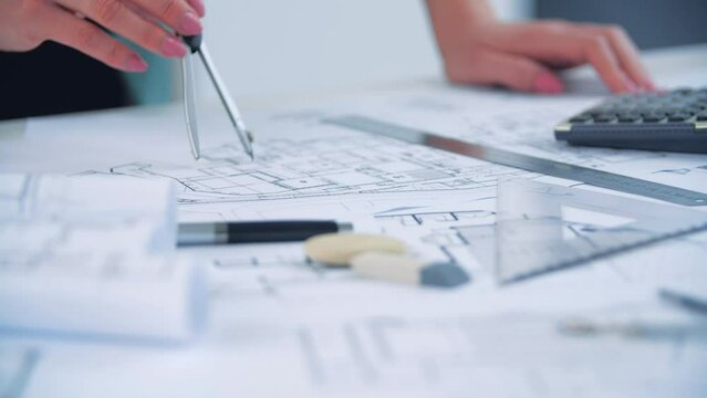 4k video of close up engineer hand sketching a construction project.