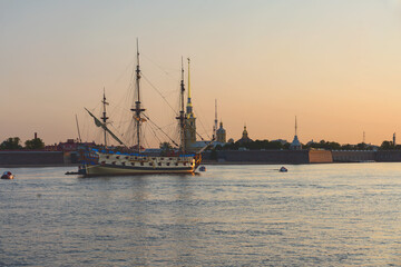 Russian old military sailboat stands on the Neva River near the Peter and Paul Fortress in the center of St. Petersburg