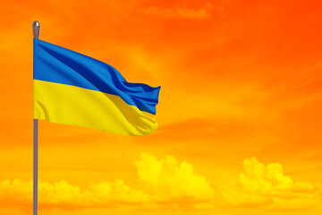 Ukraine flag on the orange sky. Close up waving flag of Ukraine with place for your text. Flag symbols of Ukraine. 3d rendering.