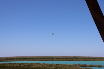 Plane flying over Roebuck Bay, Broome, Western Australia.