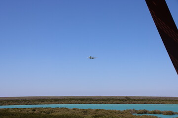 Plane flying over Roebuck Bay, Broome, Western Australia.