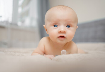 Funny and beautiful baby on the bed. children's health. 