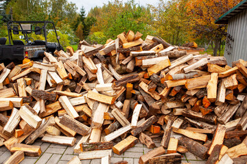 Stock of firewood for heating the house. The trees were cut down and split into firewood to be used as heating fuel in fireplaces and stoves, firewood background.