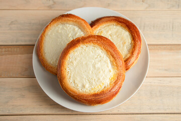 Homemade buns with cottage cheese on wooden background. Gluten free pastries.