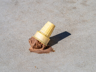 Chocolate Ice Cream cone melting after being dropped onto the ground.