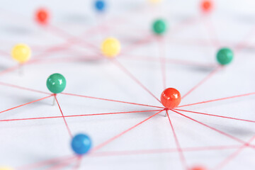 Linking entities, Blockchain, social media, Communications Network, The connection between the two networks. Network simulation on paper linked together by yarn