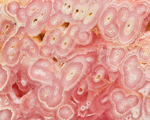 Patterns in a stalactite of the mineral rhodochrosite, close up
