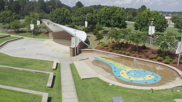 High aerial view circle right to left of amphitheater with water fountain