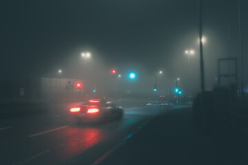 braking car on the street in dark and foggy night