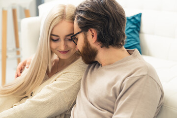 beautiful intimate bond between long-haired blonde woman and her bearded spouse . High quality photo