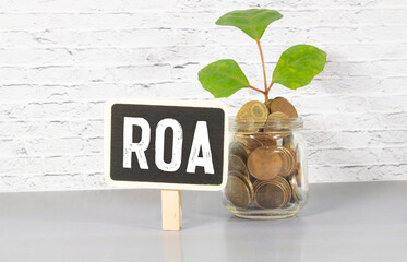 Alphabet letter in word ROA Abbreviation of Return on assets on wood background