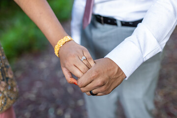 Indian married couple's holding hands close up