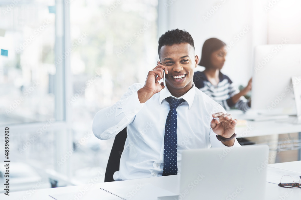 Canvas Prints Things always go according to plan when youve planned ahead. Shot of a young businessman making a phone call at his office desk with a colleague working in the background.