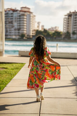 Woman walking away and pulling on dress