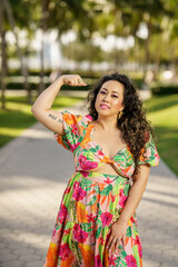 Naklejka premium She is smiling and flexing her arm muscles