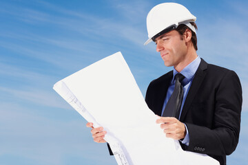 Smart architect looking at a new construction plan. Portrait of smart architect looking at a construction plan.