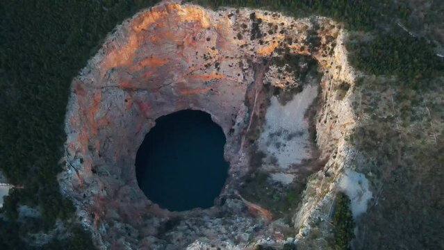 Red Lake (Croatian: Crveno jezero) is a collapse doline (collapse sinkhole) containing a karst lake close to Imotski, Croatia. It is 530 meters deep, thus it is the largest collapse doline in Europe.
