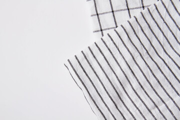 Plaid material. Towel on the table. Wrinkled fabric with stripes.