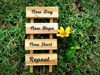 Motivational and inspirational quotes on wooden blocks - New day, new hope, new start and repeat....