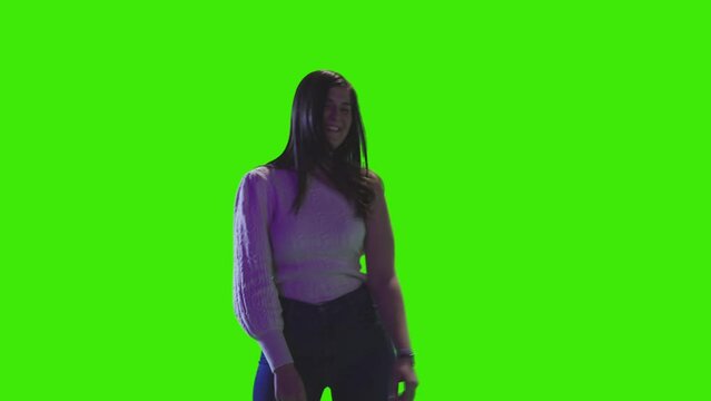A cute girl is dancing and chilling on greenscreen