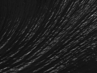 Abstract black rippling background