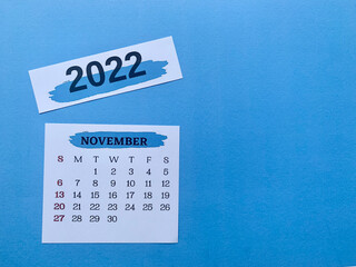 November 2022 white calendar with blue background. 2022 new year concept