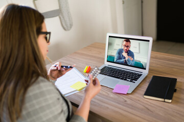 Rear view of a therapist and a patient on teleconference