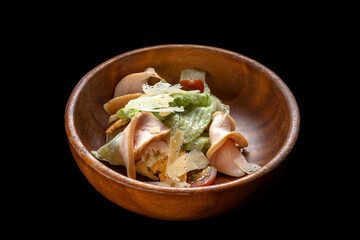 Caesar Salad with Grilled Salmon on wooden Plate Isolated. Salad with Red Fish Fillet, Mini Baguette Crackers.