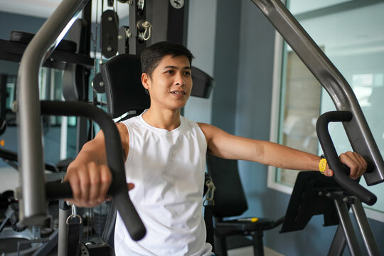 Asian men doing chest exercise at gym