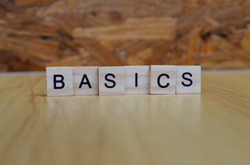 basics text on wooden square, business and motivation quotes