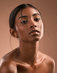 My lungs were riddled with our fears. Portrait of a beautiful young woman posing against a brown background.