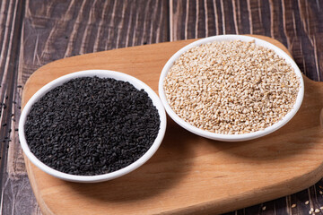 White sesame seed and black sesame  in a plate on wooden table