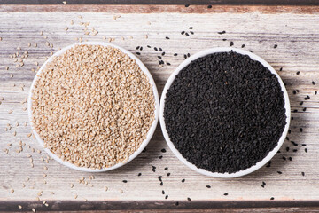 White sesame seed and black sesame  in a plate on wooden table