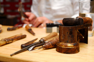 Cobbler tools, shoemaker concept, Cobbler's work table, set of leather craft tools on wooden background