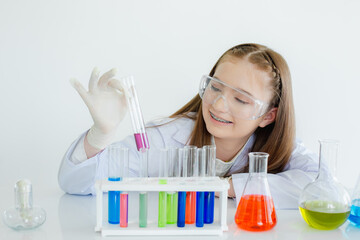 child girl science students study research liquid chemical experiments in white laboratory room....