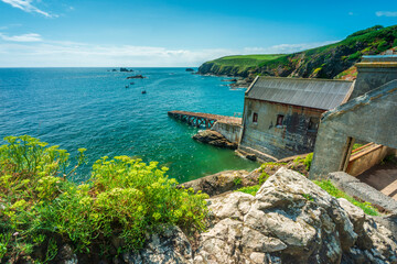 The Lizard peninsula lifeboat shed and ramp into sea,,clifftop and rocky cove in...
