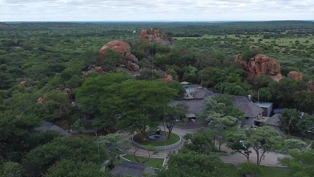 Aerial drone shot orbiting around the entrance of a holiday safari resort located in the remote African bushveld, South Africa