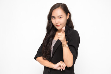 Obraz premium Beautiful Asian business woman wearing black suit pointing finger at camera presenting something on white background and copy space. Confident Asian working woman smiling and cheerful