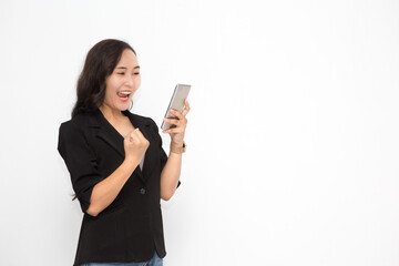 Beautiful Asian business woman wearing black suit holding smartphone on white background and copy space.  Confident Asian working woman excited and cheerful