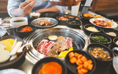 Korea bbq style restaurant  with meat and vegetable side dish.