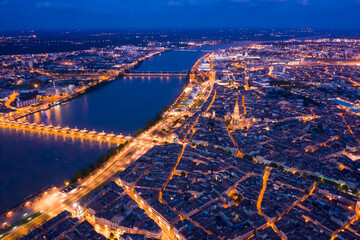 Panoramic aerial view of illuminated Bordeaux city on Garonne river at night - obrazy, fototapety, plakaty