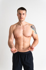 Fototapeta premium Fish oil is eaten by a man in the hands of vials and a glass bottle pill health supplement, medical yellow lifestyle, cod. white translucent, eat female giving dieting