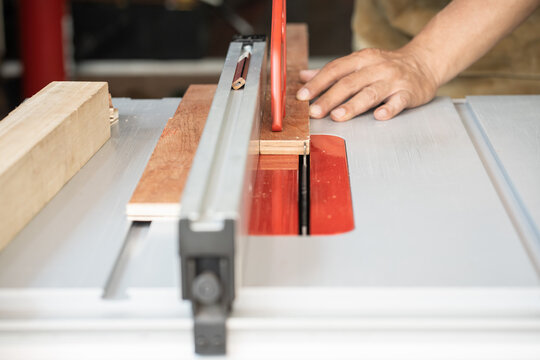 carpenter use push sticks or push blocks on table saw , push sticks control wood , Keeps hands and fingers safe from the blade,woodworking concept. selective focus