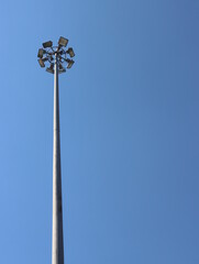 A large lamppost against a bright sky background.
