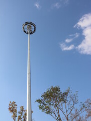 A large lamppost against a bright sky background.