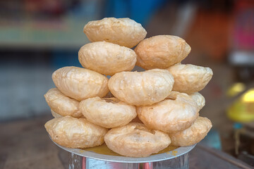The image of an Indian deep-fried pastry is locally known as the Khaja. It's a popular sweet dish of Odisha, Andhra Pradesh, Bihar, Jharkhand, and Nepal. Selective focus