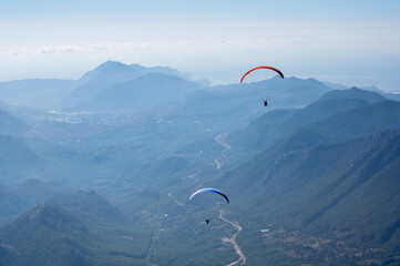 Paragliders flying over mountains