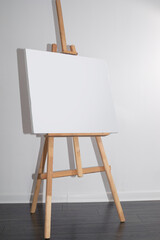 wooden easel with blank canvas