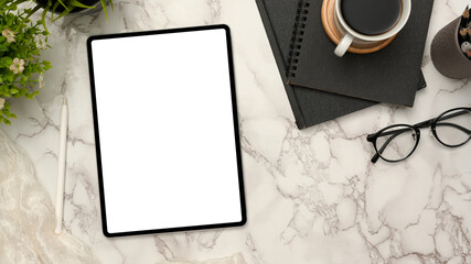 Modern workspace with portable tablet on marble white background.