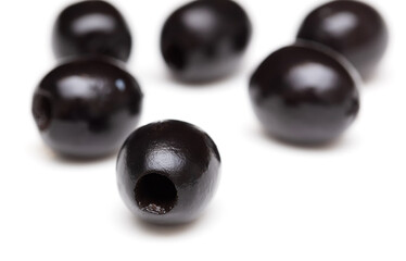 Black olives isolated on a white background.